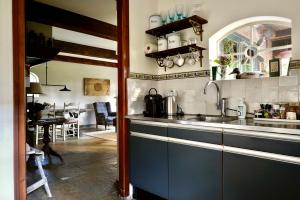 a kitchen with a sink and a counter top at De Fazant in Laren