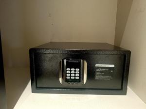 a microwave with a cell phone inside of it at Crystal Residency - Panjappur Trichy in Pūngudi