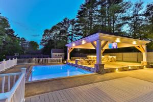 a pool with a gazebo next to a swimming pool at Beachside family POOLSPAOPEN20thAPril in Barnstable