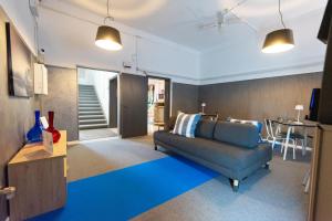 a living room with a couch and a table at LUDO Holiday House in Riccione