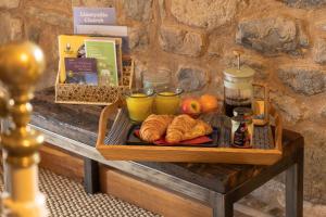 a tray of food on a table with drinks and croissants at The Cowshed in Llangollen