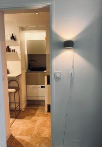 a light on a wall in a room at Stylish studio 3-4p with AC and balcony near Champs-Élysées in Paris +10 photos