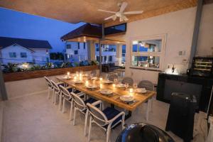 a long wooden table with chairs and lights on it at Villa Natali between Rawai and Nai Harn in Rawai Beach