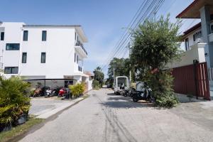an empty street with motorcycles parked next to a building at Villa Natali between Rawai and Nai Harn in Rawai Beach