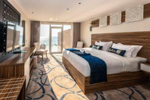 a hotel room with a large bed and a television at نزل رالين للنزل السياحية in Al Wajh +71 photos