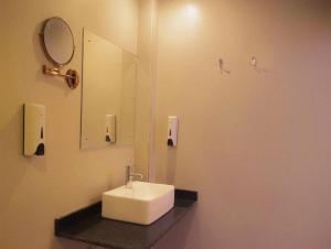 a bathroom with a sink and a mirror at hotel Gautam Inn in Gorakhpur