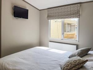a bedroom with a white bed and a window at Beamish Holiday Park in Stanley