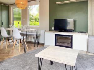 a living room with a fireplace and a tv at Beamish Holiday Park in Stanley