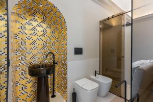 a bathroom with a sink and a toilet at Torre Saracena Massa Lubrense in Massa Lubrense