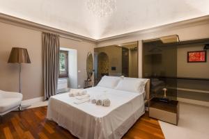 a bedroom with a white bed with towels on it at Torre Saracena Massa Lubrense in Massa Lubrense