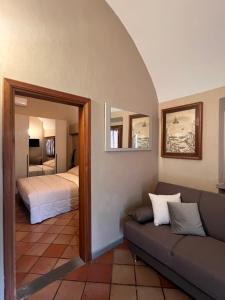 a living room with a couch and a bedroom at Casa le valli in Cantagrillo +42 photos
