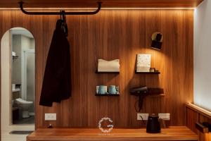 a bathroom with a wooden wall with a mirror and a sink at Zao Orange Homestay in Taitung City +34 photos