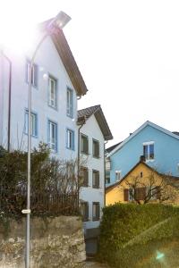 a street light in front of a white building at Herti14 Serviced Apartments in Ennetbaden