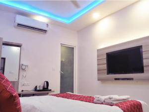a bedroom with a flat screen tv on the wall at hotel Gautam Inn in Gorakhpur +20 photos