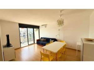 a living room with a table and a couch at Apartamento Summer Place in Monte Gordo