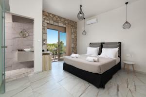 a bedroom with a large bed and a bathroom at Drakos Estate - Luxury Pool Villas in Asgourou +76 photos
