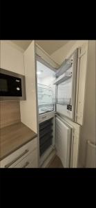a kitchen with an empty refrigerator and a microwave at Dove Cottage in Greenock +10 photos