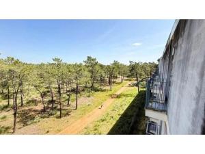 a balcony of a building with a view of a field at Apartamento Summer Place in Monte Gordo