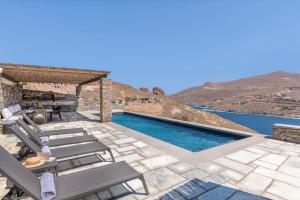 a villa with a swimming pool with a view at Lithi House in Grionísi