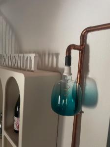 a blue glass light hanging from a wall at Antico Glicine in Ispra