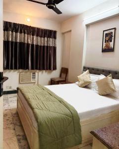 a bedroom with a large bed and a window at Divine Abode in Thane