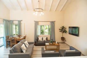 a living room with a couch and a table at Almond Tree Villa Beach Hideaway with Jacuzzi in Gros Islet