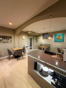 a large kitchen and dining room with a table and chairs at Sawei Urban Hotel in Craiova