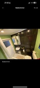 a bathroom with a toilet and a sink at Zimmer für 2 Monteure in Heppenheim Kirschhausen in Kirschhausen +4 photos