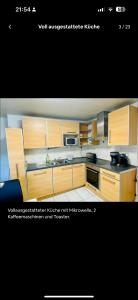a kitchen with wooden cabinets and a stove top oven at Zimmer für 2 Monteure in Heppenheim Kirschhausen in Kirschhausen