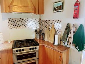 a kitchen with a stove and a counter top at Ailsa Seaview in Turnberry