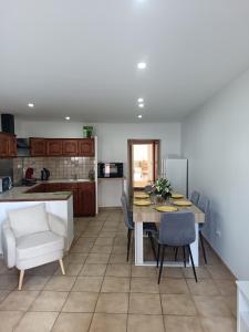 a kitchen and dining room with a table and chairs at Maison le Flamant in Port-Saint-Louis-du-Rhône