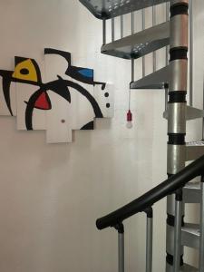 a staircase with a painting of a bird on the wall at Antico Glicine in Ispra