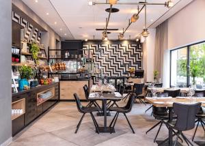 Prima City Hotel في تل أبيب: مطعم فيه طاولات وكراسي في الغرفة