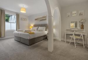 a bedroom with a bed and a desk and a table at Quayside Marina in Torquay