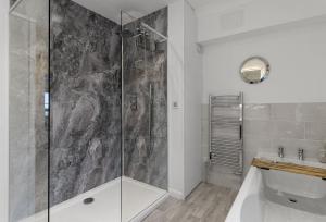 a bathroom with a shower with a glass door at Quayside Marina in Torquay +14 photos