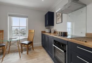 a kitchen with a table and a counter top at Quayside Marina in Torquay