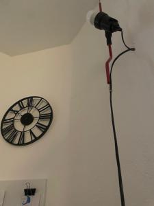 a camera attached to a wall with a clock on it at Antico Glicine in Ispra