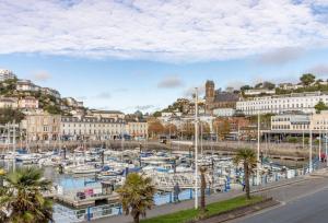 a marina in a city with boats in the water at Quayside Marina in Torquay