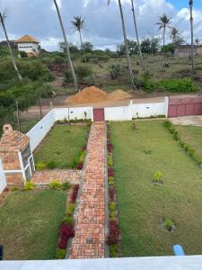 a brick walkway in a yard with a garden at Carinho da Paz in Inhambane