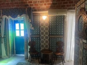 a room with a blue door and a window at Hôtel Bou Fares in Sidi Bou Saïd