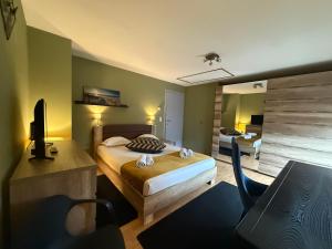 a bedroom with a bed and a desk and a chair at Seraphina in Zaventem +14 photos