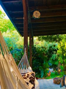 a hammock with a clock on top of it at Villa Aggeliki in Prinos