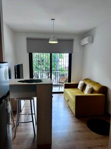 a living room with a couch and a table at Terrazas de Godoy in Godoy Cruz