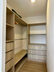 a walk in closet with wooden shelves at Terrazas de Godoy in Godoy Cruz