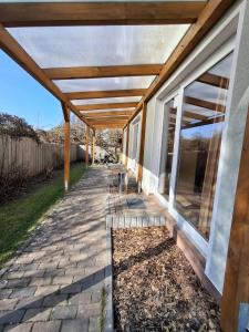 a patio with a pergola on the side of a house at Wandlitz-Pension Dampflok in Wandlitz +8 photos