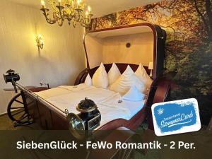 a bed in a room with a sign on it at Siebenglück - 4 FeWo's mit SommerCard in Winterberg