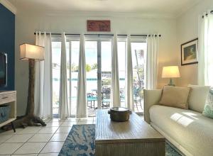 a living room with a couch and a view of the ocean at Seas the Keys Getaway in Duck Key