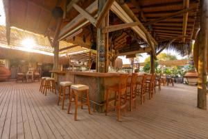 an outdoor bar with chairs and tables in a restaurant at Kefi Beach & Suites in Ortakent