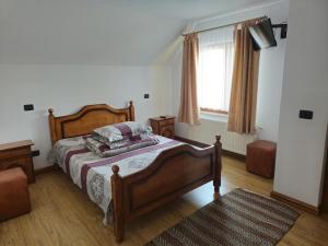 a bedroom with a bed and a window at Casa Paty in Mănăstirea Humorului