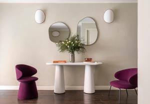 a table with two chairs and a mirror at Barberini Retreat Boutique Hotel in Rome +53 photos